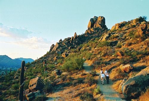 Image of a group of people hiking up a hillside